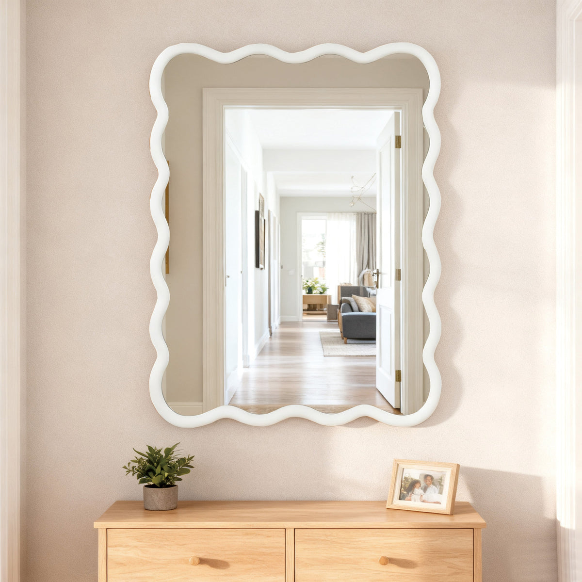 Wavy wood bathroom mirror styled above a simple vanity