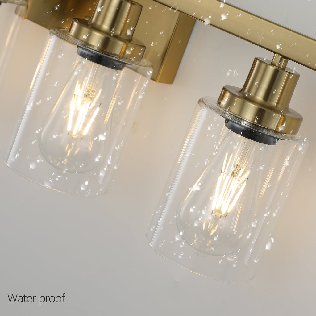 Gold bathroom vanity light shown over double-sink mirror