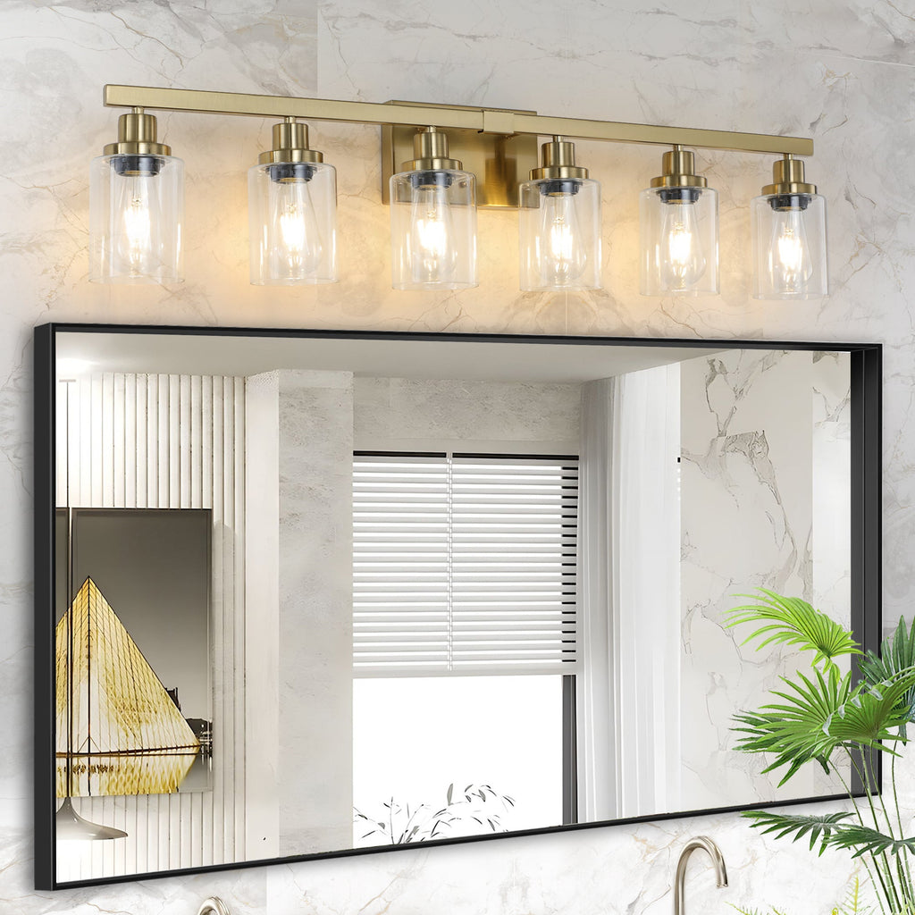 Golden six-light bathroom vanity light with clear glass shades above mirror