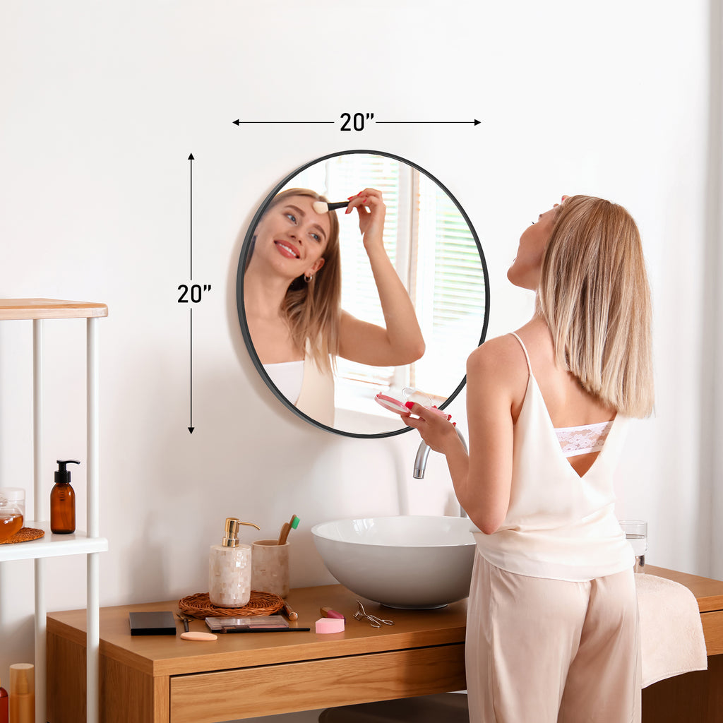 Round wall mirror styled above a bathroom vanity