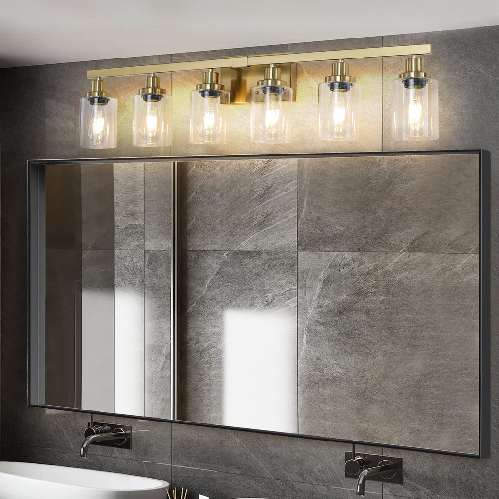 Six-light gold vanity fixture with clear glass shades in bright bathroom