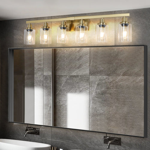 Six-light gold vanity fixture with clear glass shades in bright bathroom